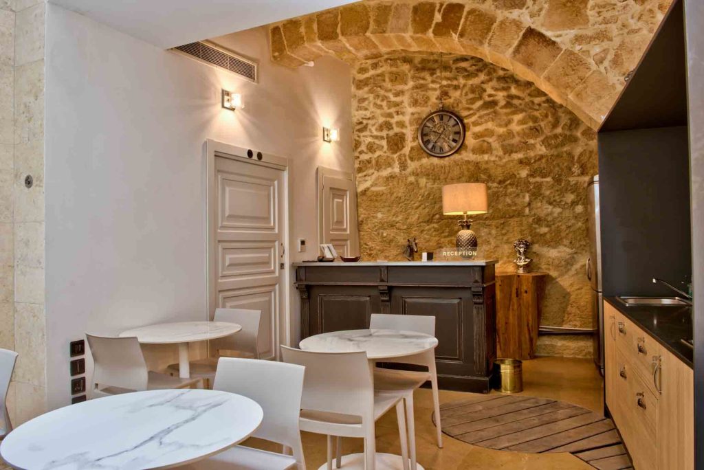 50th Boutique Hotel and Kitchenette area featured on a stone wall